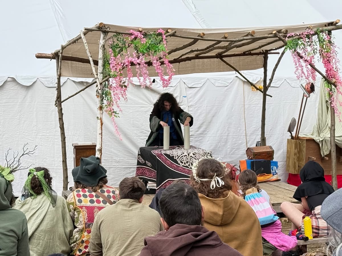 A festival attendee smiling in full Renaissance clothing